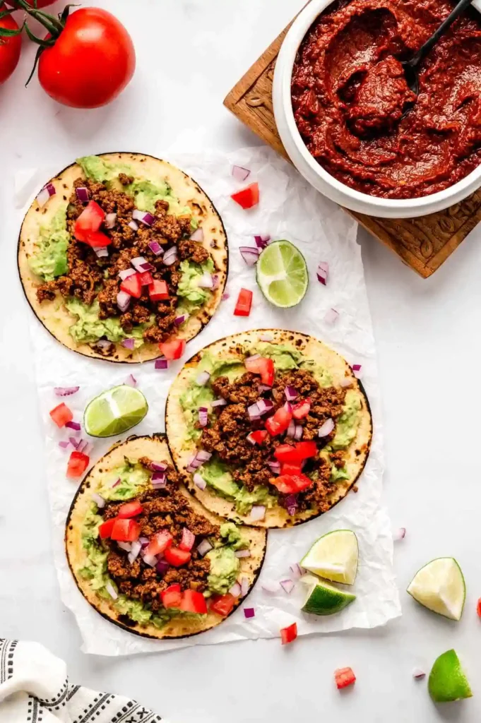 Hello Fresh Tex Mex Paste 3 Tacos with homemade Tex Mex paste, guacamole, and meat on tortillas with tomato and onion