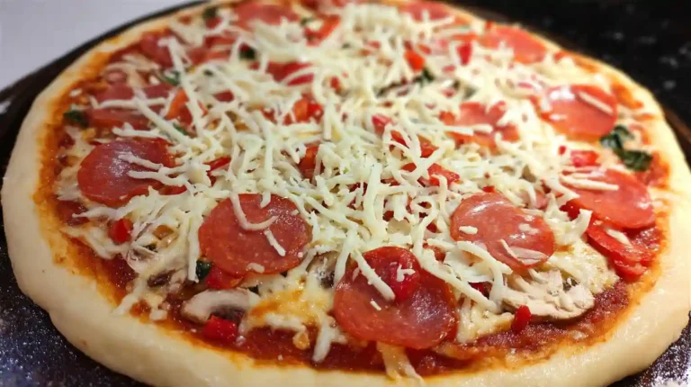 Freshly made homemade pizza dough ball on floured wooden cutting board ready for rolling