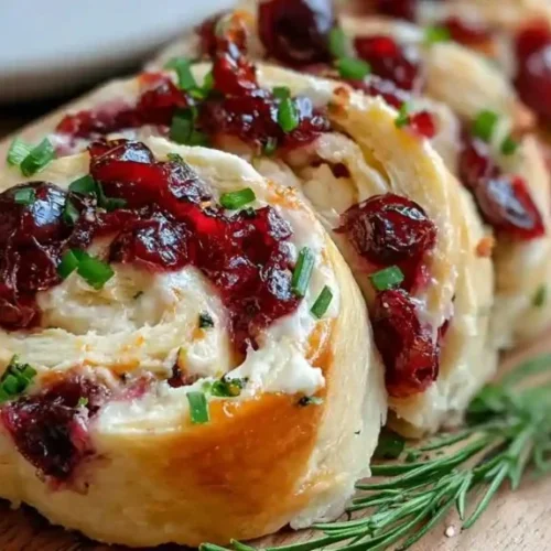 Savory Christmas Cranberry Roll-Ups served on a festive platter