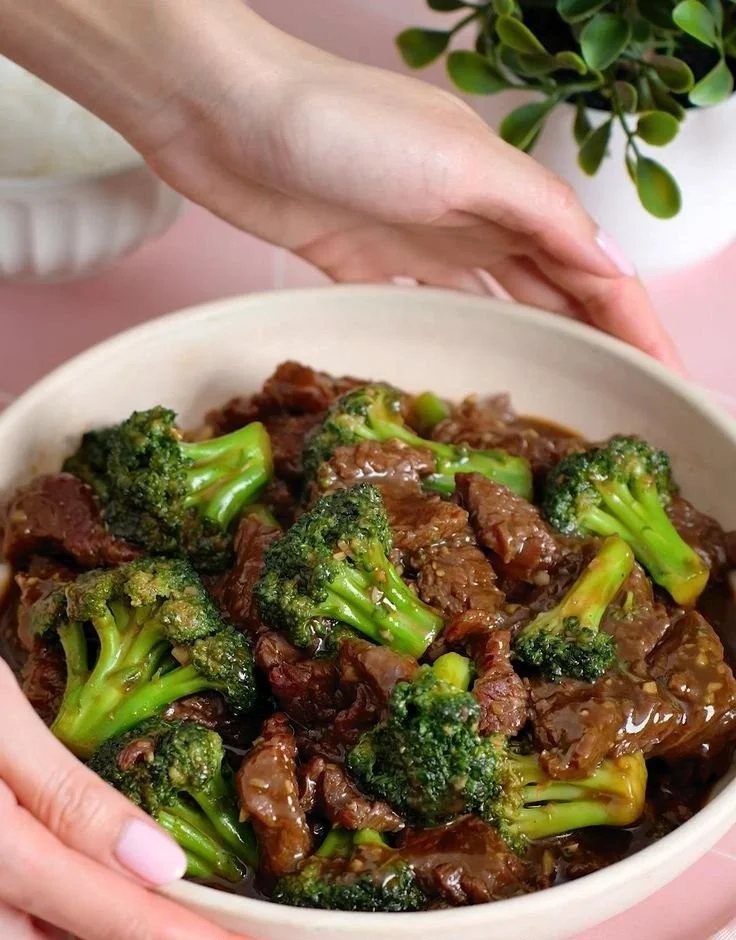 Delicious Beef and Broccoli Stir-Fry served on a plate with rice and vegetables