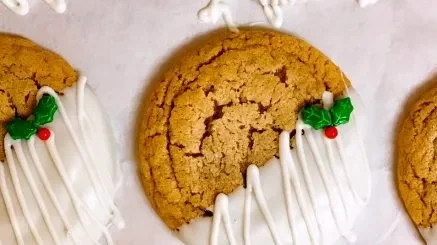 Chewy maple cinnamon cookies dipped in white chocolate on a plate.