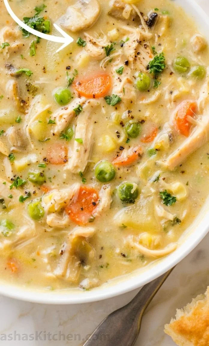 Delicious Chicken Pot Pie Soup topped with herbs in a bowl.