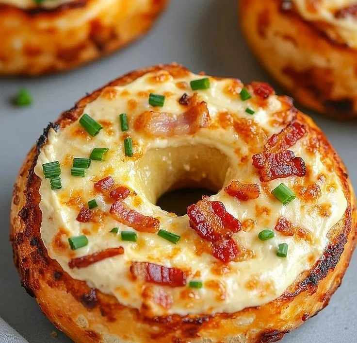 Creamy bacon cheddar bagels topped with melted cheddar cheese and crispy bacon