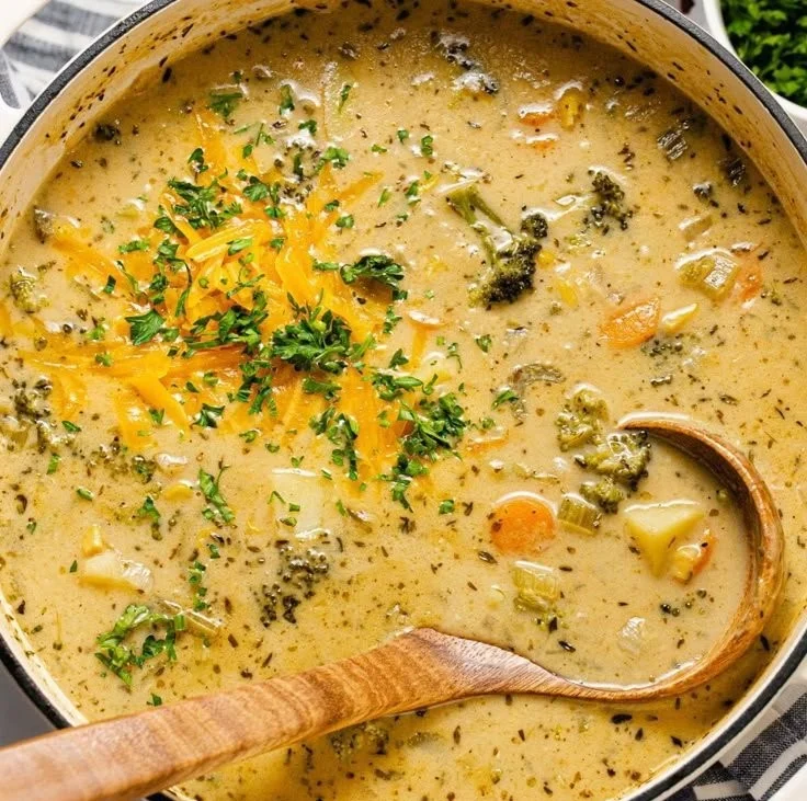 Delicious creamy vegetable soup garnished with fresh herbs and vibrant vegetables