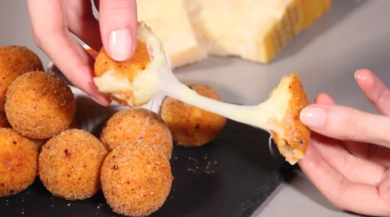 Plate of crispy potato cheese balls served with dipping sauce