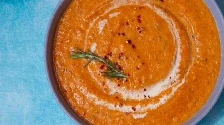 Bowl of delightful roasted vegetable soup filled with colorful vegetables.