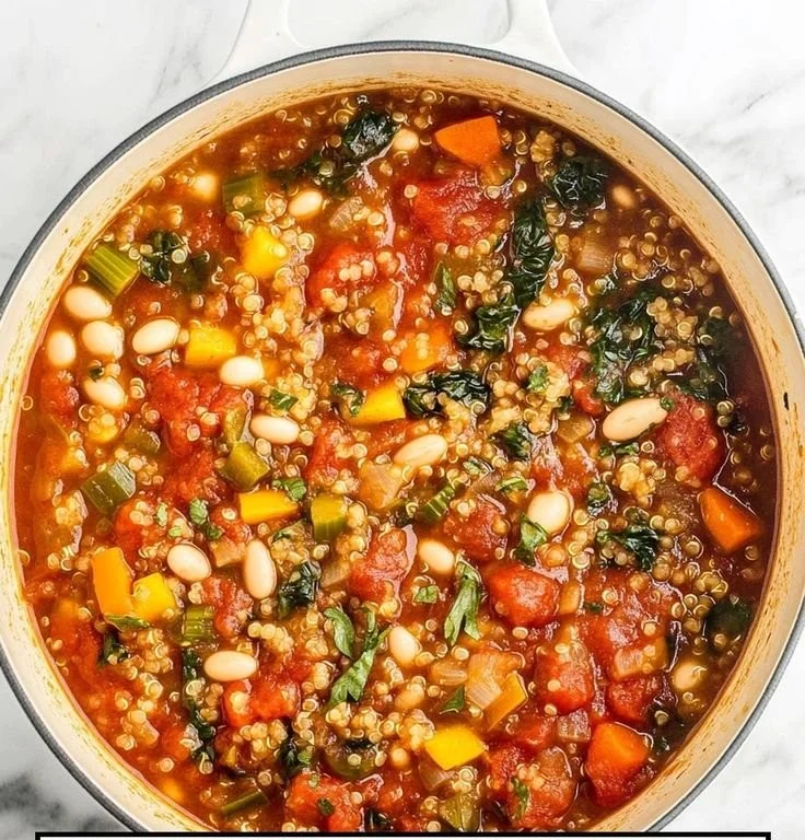 Bowl of healthy quinoa vegetable soup with fresh vegetables