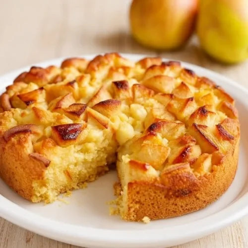 Slice of Italian-style apple cake with fresh apples and cinnamon