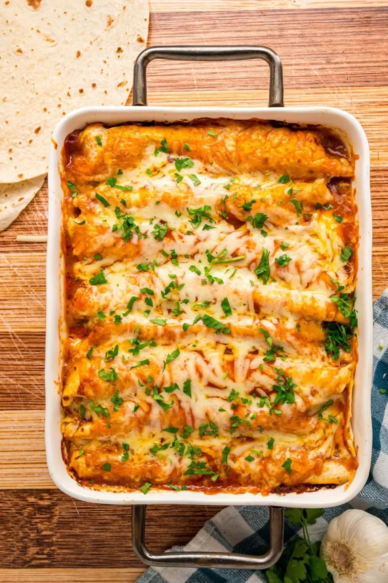 Delicious homemade Chicken Enchiladas topped with melted cheese and fresh salsa.