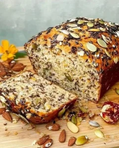 Delicious slice of flourless oatmeal bread on a wooden table