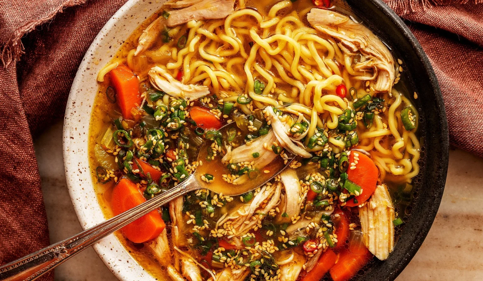 Ginger-Scallion Chicken Soup Bowl of Ginger-Scallion Chicken Soup garnished with fresh scallions.