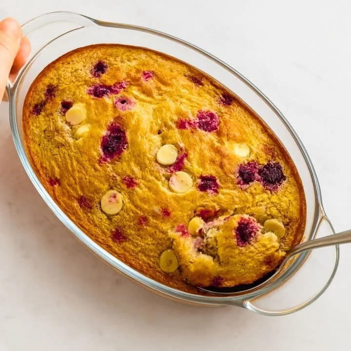 Bowl of healthy baked oats topped with fresh fruits and nuts
