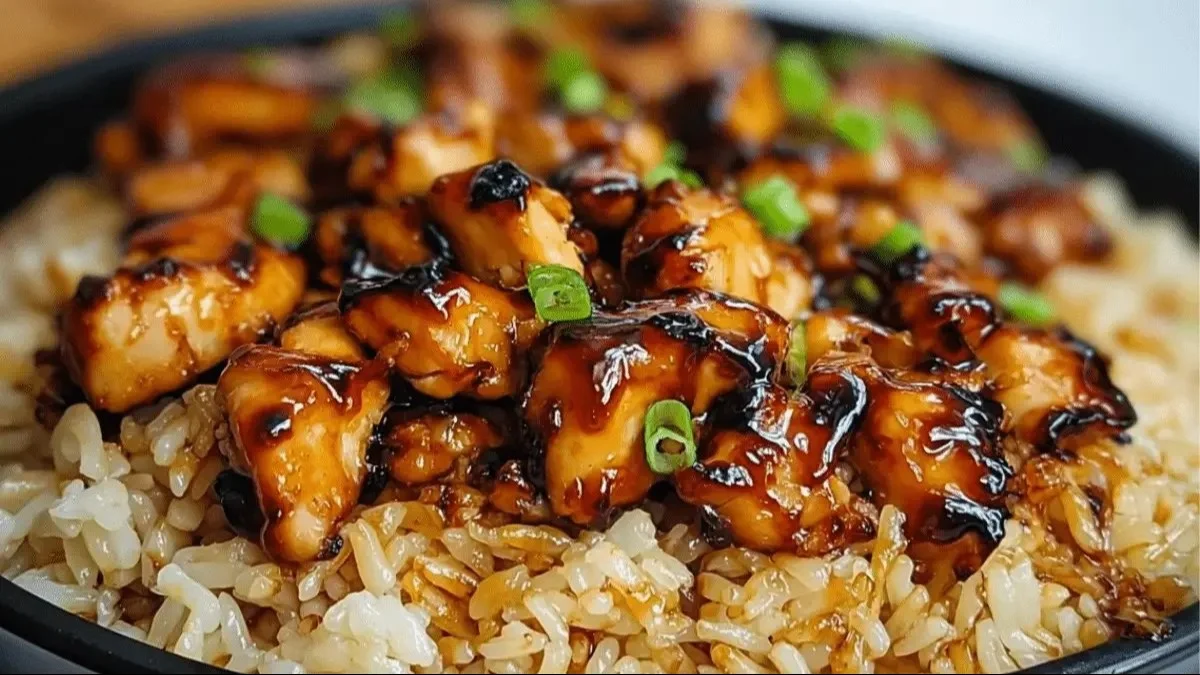 Honey BBQ Chicken served over rice, garnished with fresh herbs.