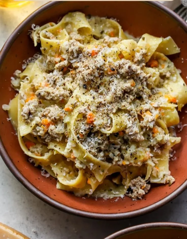 Plate of White Bolognese with Pappardelle garnished with herbs