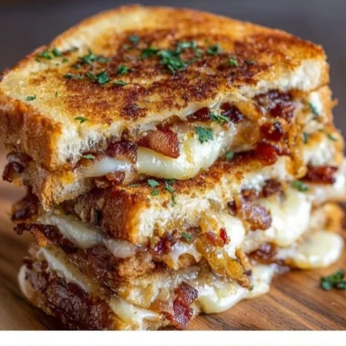 Bacon and caramelized onion grilled cheese sandwich with melted cheese