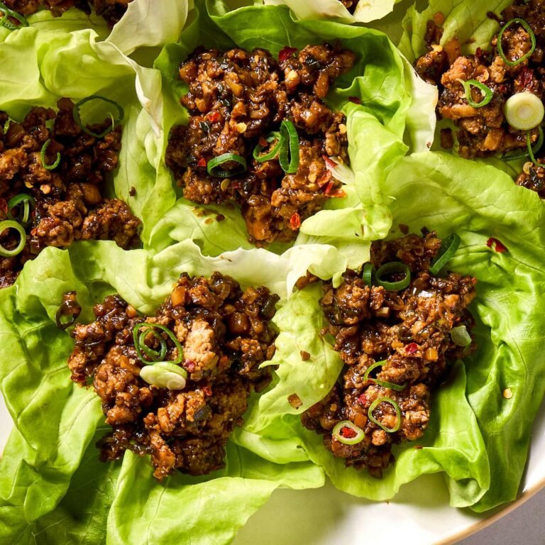 Chicken lettuce wraps with rice served with avocado and fresh vegetables