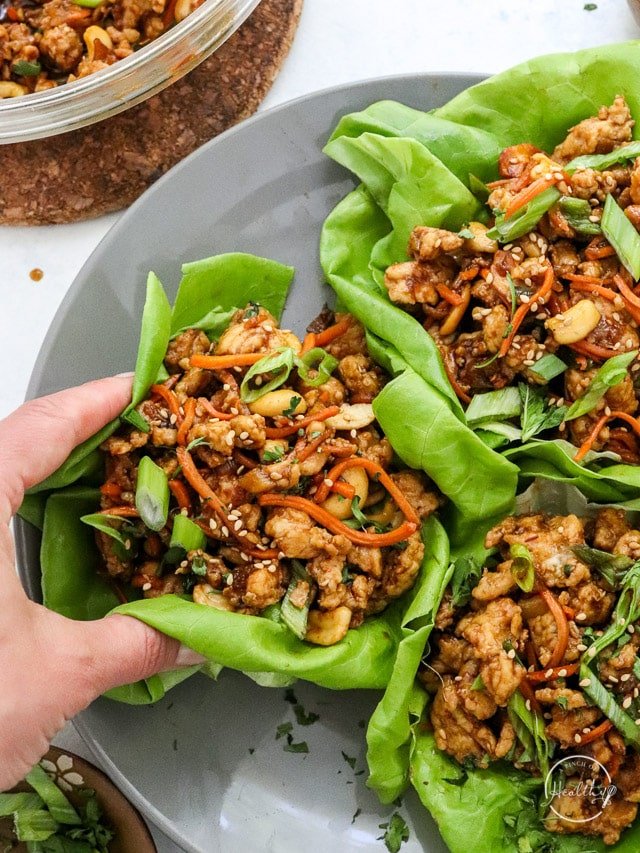 Chicken lettuce wraps with rice served with avocado and fresh vegetables