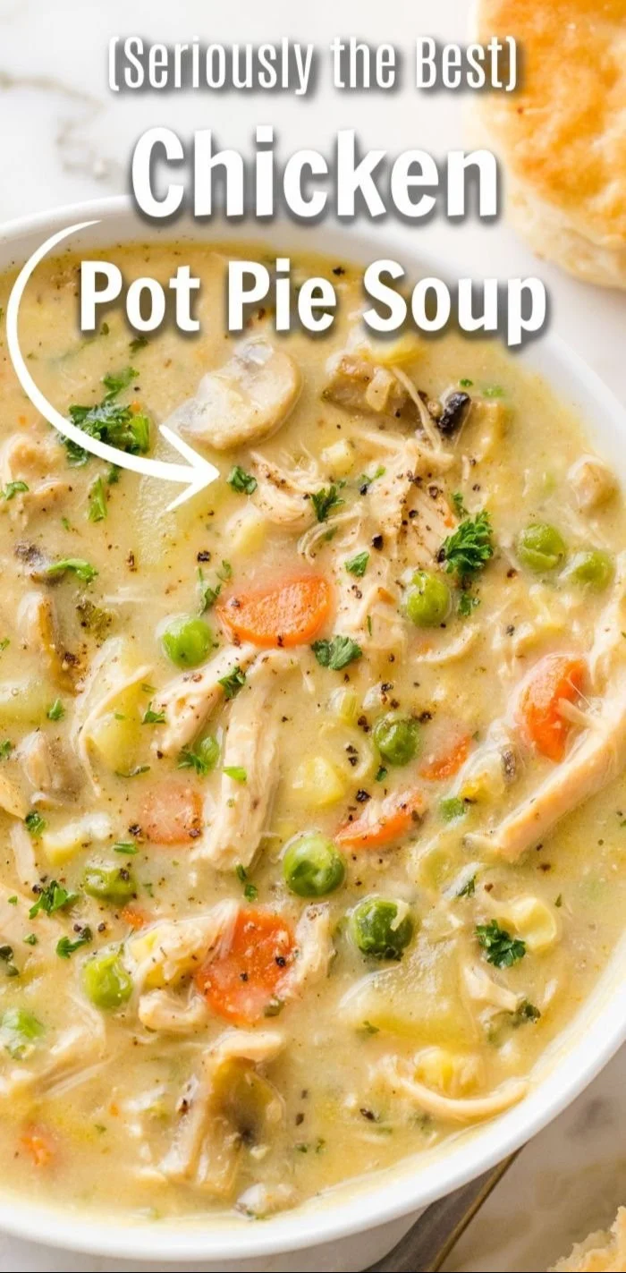 Delicious Chicken Pot Pie Soup served in a white bowl with fresh vegetables.