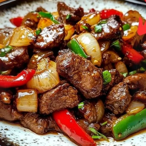 Delicious classic pepper steak served with vibrant bell peppers and savory sauce.