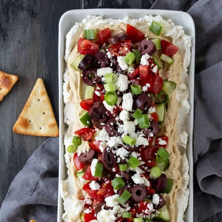 Delicious Layered Greek Dip topped with fresh Mediterranean ingredients