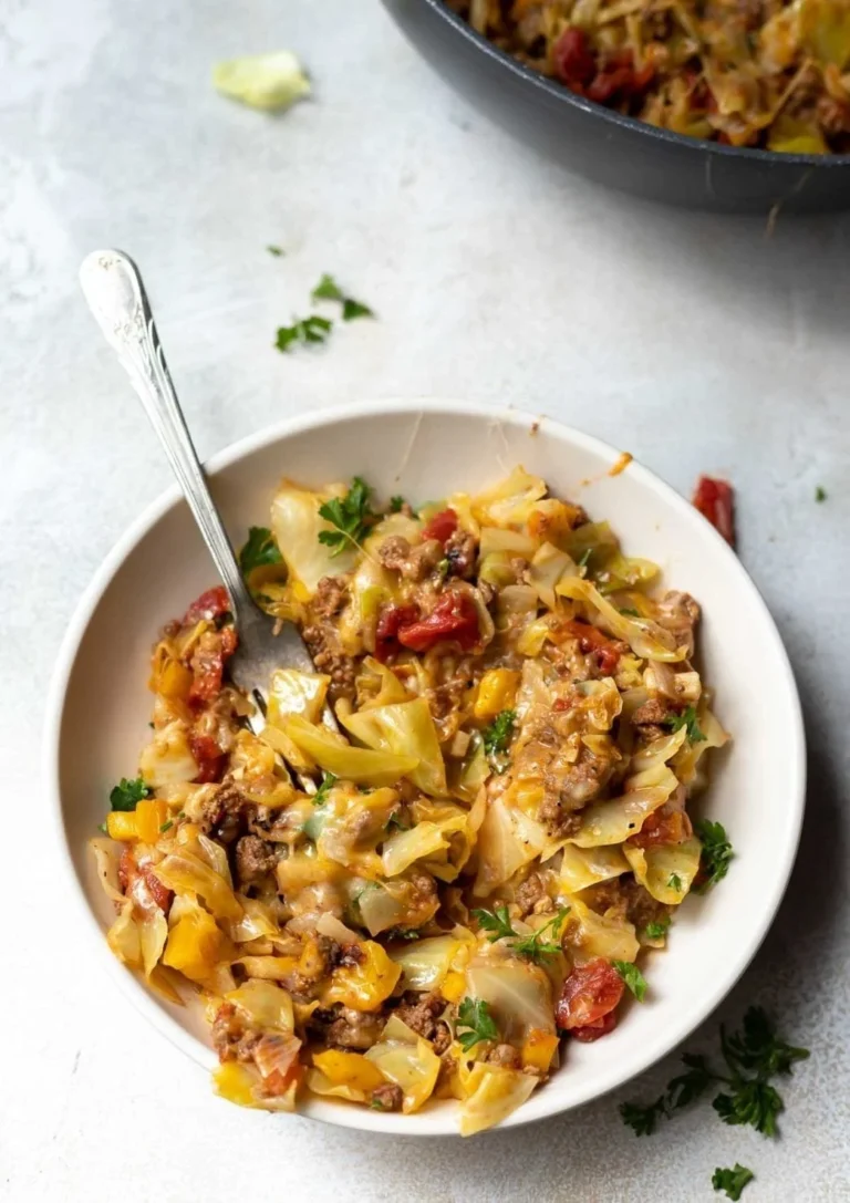Low carb unstuffed cabbage casserole served in a baking dish with garnishes.