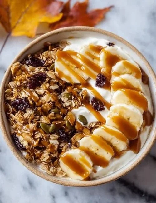 Delicious salted caramel banana yogurt bowl topped with fresh bananas.