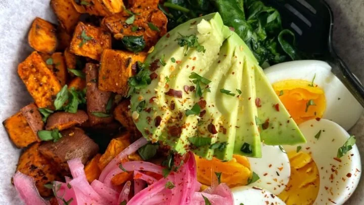 Healthy Sweet Potato Breakfast Bowl topped with nuts and fruits