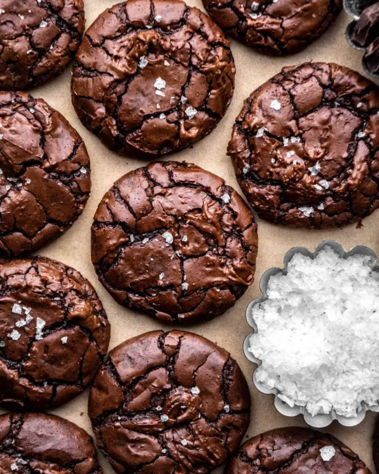 Delicious brownie cookies stacked on a plate, with chocolate chips visible.