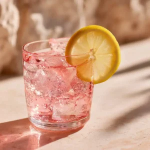 Pink gelatin recipe served in a white ceramic bowl, a healthy low-calorie weight loss snack made with unflavored gelatin and cranberry juice